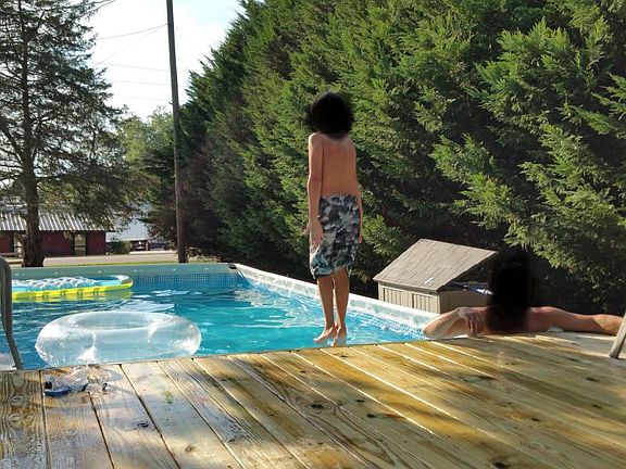 Large above ground pool with deck