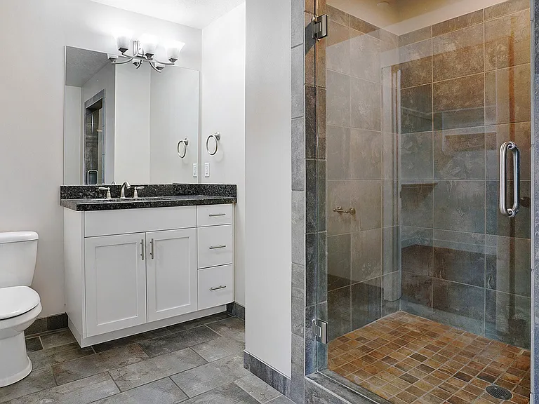 Modern bathrooms feature spacious walk-in showers and contemporary finishes.