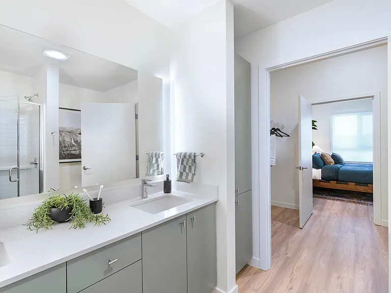Featuring sleek quartz countertops and elegant front-lit mirrors, these spaces offer a perfect blend of style and function.