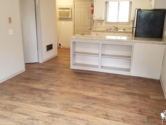 Living room with view into kitchen.