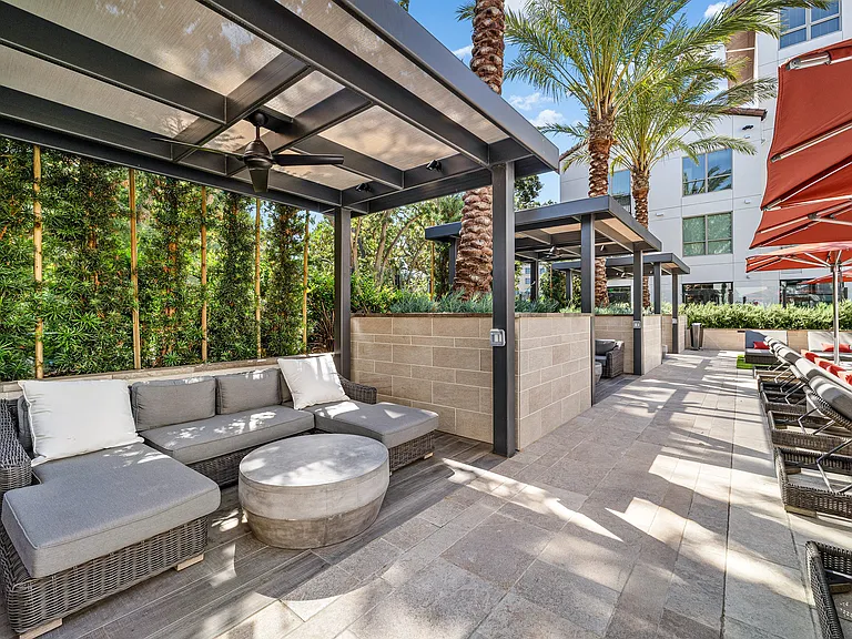 Shaded cabana seating with wicker furniture and ceiling fans
