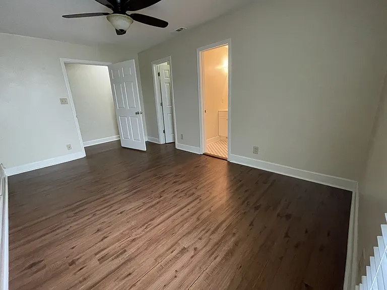 Bedroom One, looking towards hallway, walk-in closet, and ensuite bathroom. Bedrooms all have good sized windows that look onto side garden. (Fee free to help yourself to some fresh mint and oregano.)