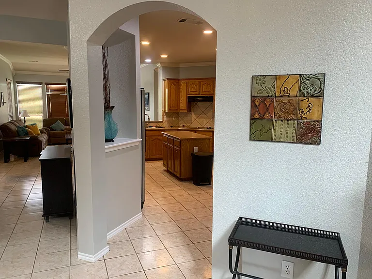 Wide archway entry to the kitchen in the front hall.