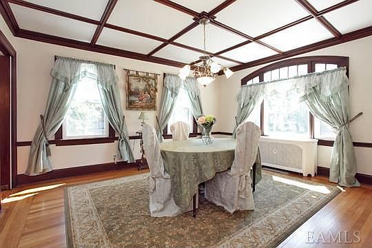 Formal Dining with Beautiful Wood Details and Original Pocket Doors.