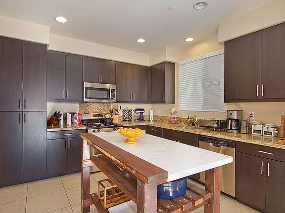 Spacious kitchen stainless steel appliances and sleek modern