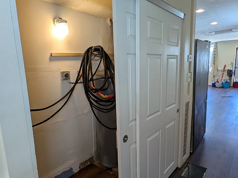 Separate laundry and utility room hidden by attractive sliding doors.