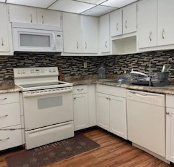 Fully equipped kitchen. Dishwasher, over the range microwave, smooth top stove, garbage disposal and refrigerator. Lots of cabinets and lights. Easy to clean floor.