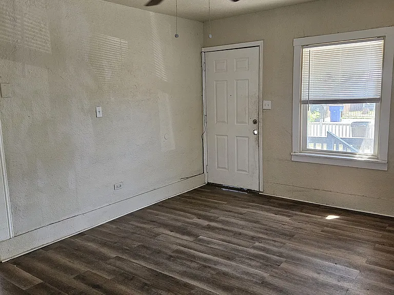 Living room with ceiling fan and mini split hvac system. Newer dual pane windows