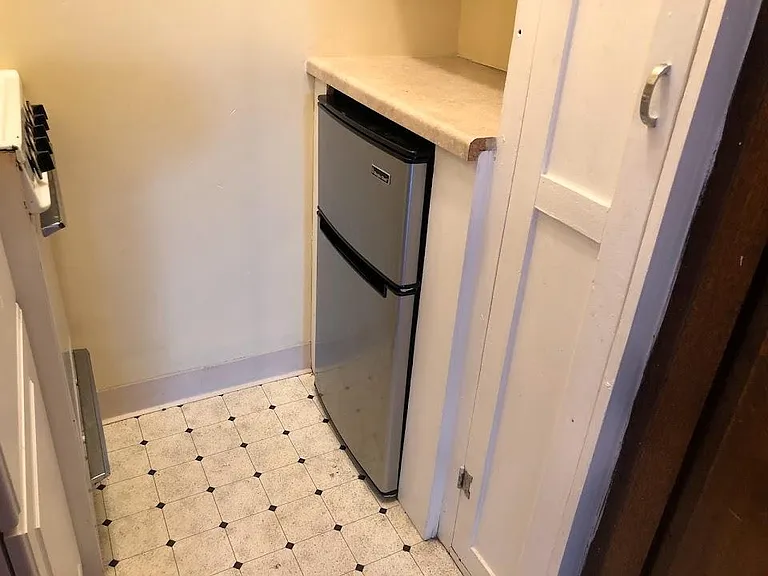 Walk-in kitchen, fridge, broom closet.