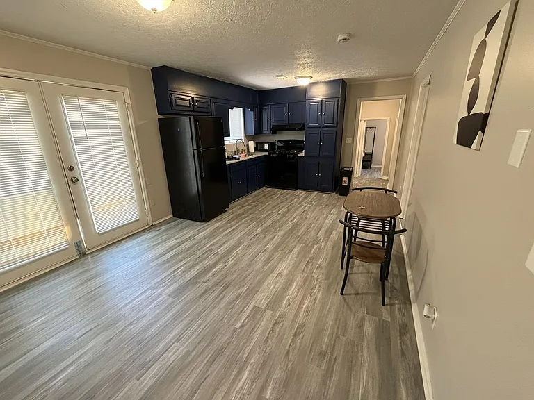 Spacious kitchen with ample cabinet storage, full appliance set, and easy access to the patio for indoor-outdoor meals.