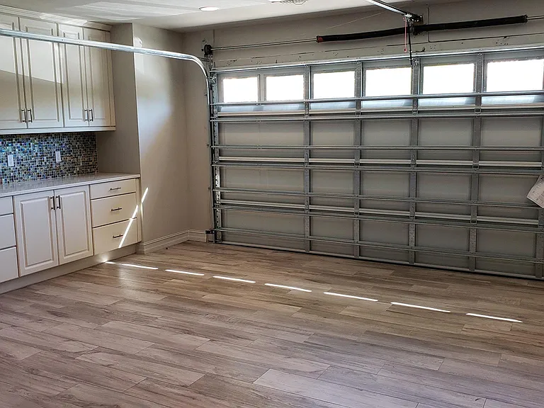 Fully Air-conditioned (separate Heat Pump) 400 sf Garage with finished tile flooring. The perfect playroom - work out room and home office