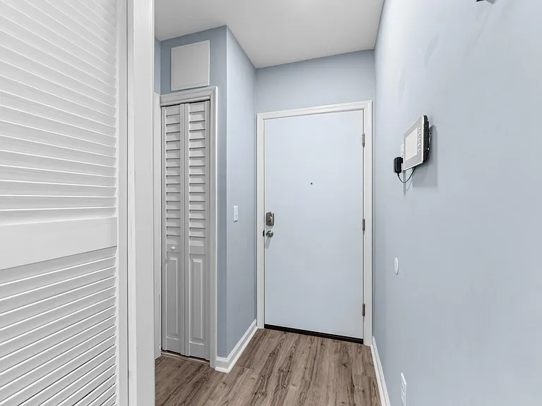 Hallway looking at main entry door to the unit.
