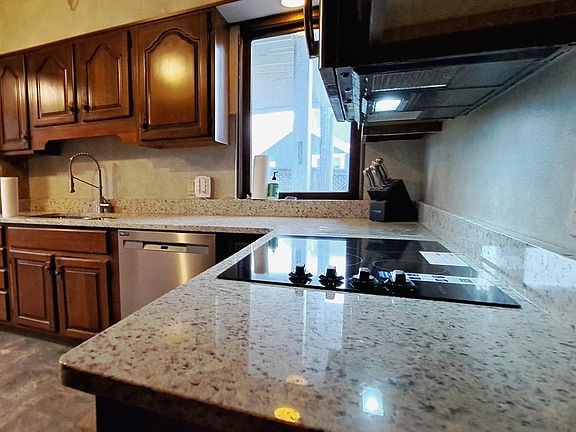 Kitchen with brand stainless steel appliances and new cooktop