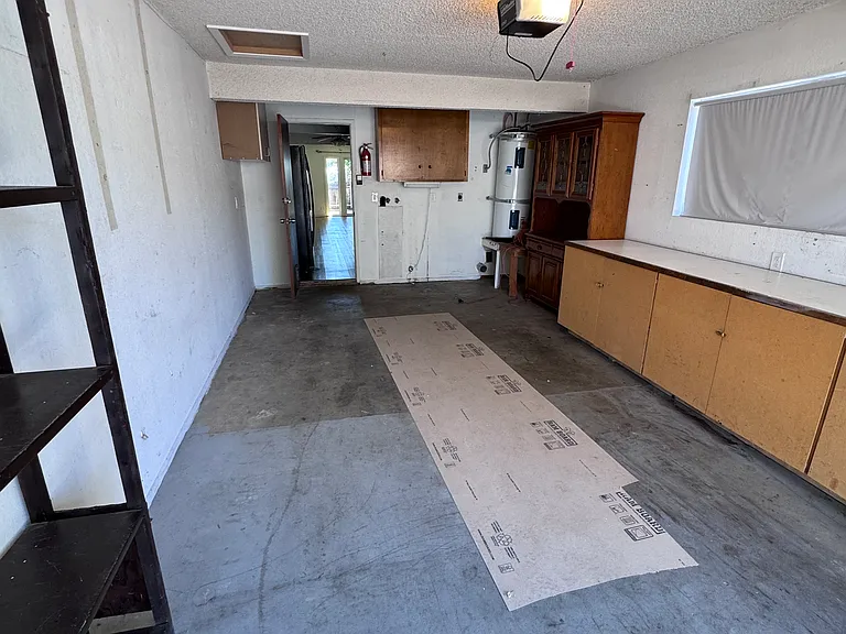 Single car garge with washer/dryer hookups. Cabinets for storage.