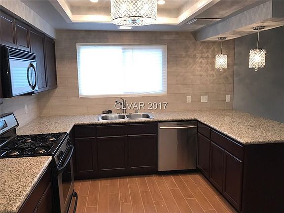 Open upgraded kitchen featuring granite counter tops and stainless steel appliances.