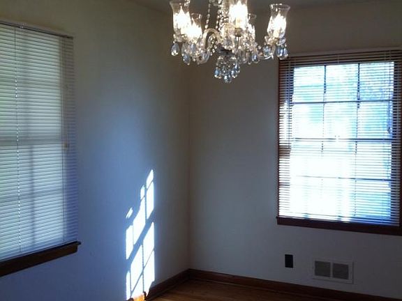 Dining room, beautiful chandelier, and hardwood floors.