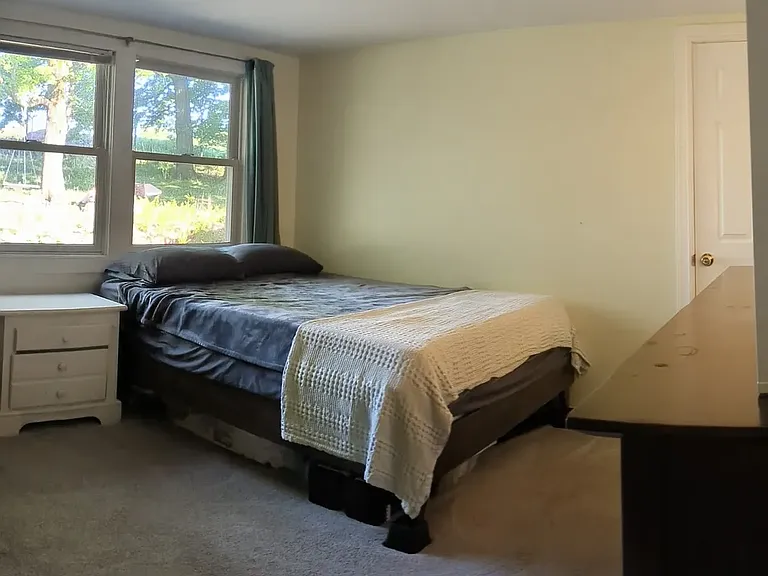Bedroom 1 facing back yard. Secondary exit to bedroom opens to kitchen