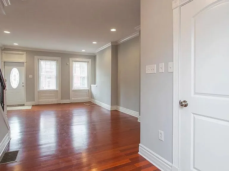 Unfurnished Living Room and Powder Room Door. View from Dining Room