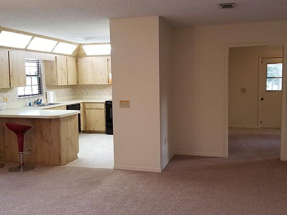 Standing in hall, looking toward kitchen and bonus room
