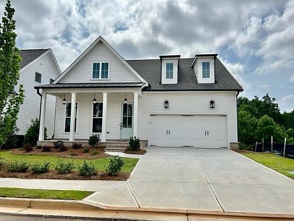 Elegant modern farm house inspired home. Full brick front rocking chair porch for relaxing.