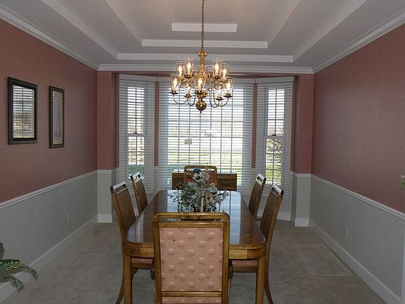 dining room with triple tray ceiling