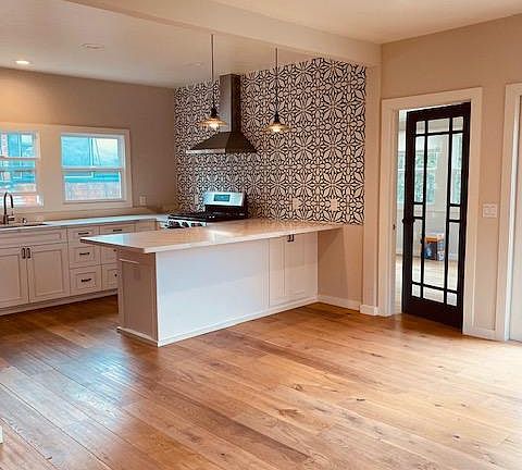 kitchen, door to bedroom. Plank Harwood floors.