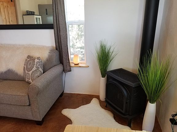 cozy gas heater, sofa sleeper, polished cement floors.