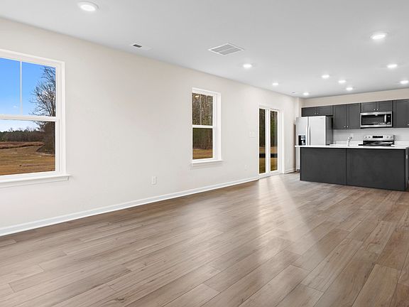 Open 1st floor living room and kitchen in a DRB Homes Glenshaw plan at The Village of College Park.