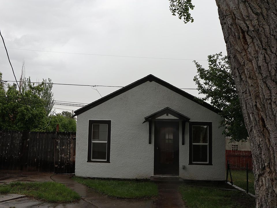 Shared yard with lawn, mature trees, and garden.