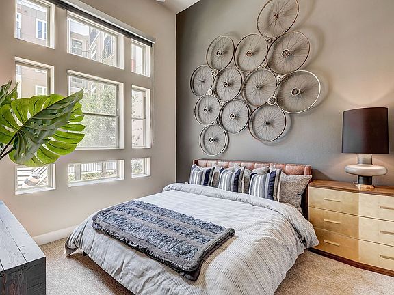 spacious bedroom with high ceilings and large windows