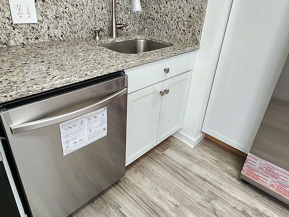 Kitchen - dishwasher with modern fixtures; sink with modern fixtures and food disposal