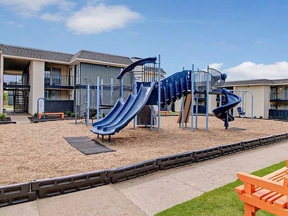 Playground area with new equipment and green space