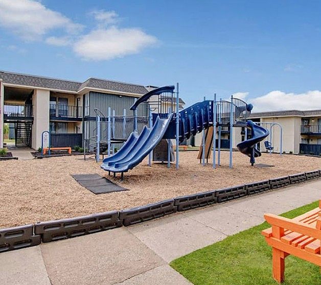Playground area with new equipment and green space