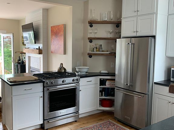 Dual fuel range and refrigerator with water and ice maker.