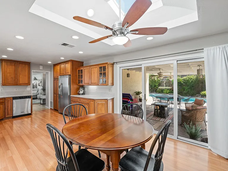 Dinning area opens to resort style backyard with pool