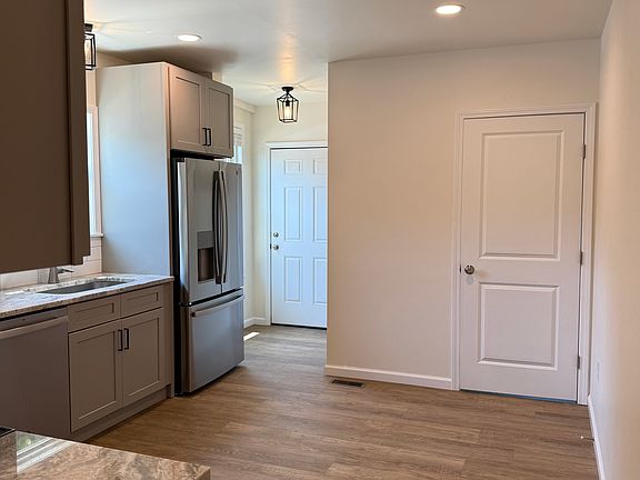 Kitchen with view of powder room and Laundry.
