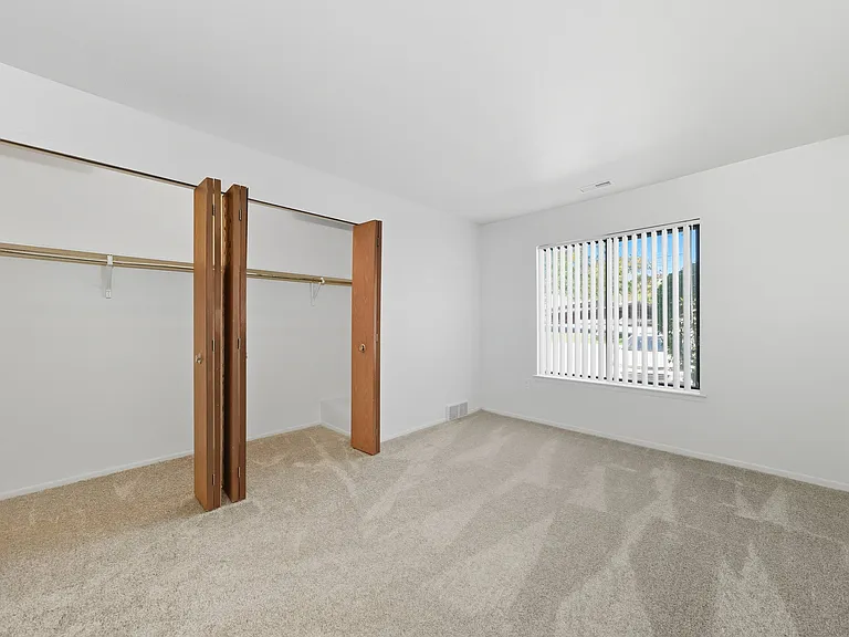 Comfortable Bedroom with natural light at Franklin River Apartments in Southfield, MI