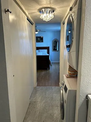 "Smart" full size washer and dryer with large closets on both sides, accented with a crystal chandelier