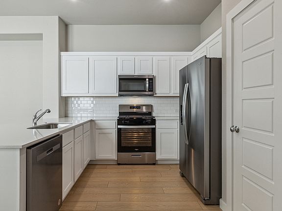 Kitchen in the Birch home plan by Trophy Signature Homes - REPRESENTATIVE PHOTO