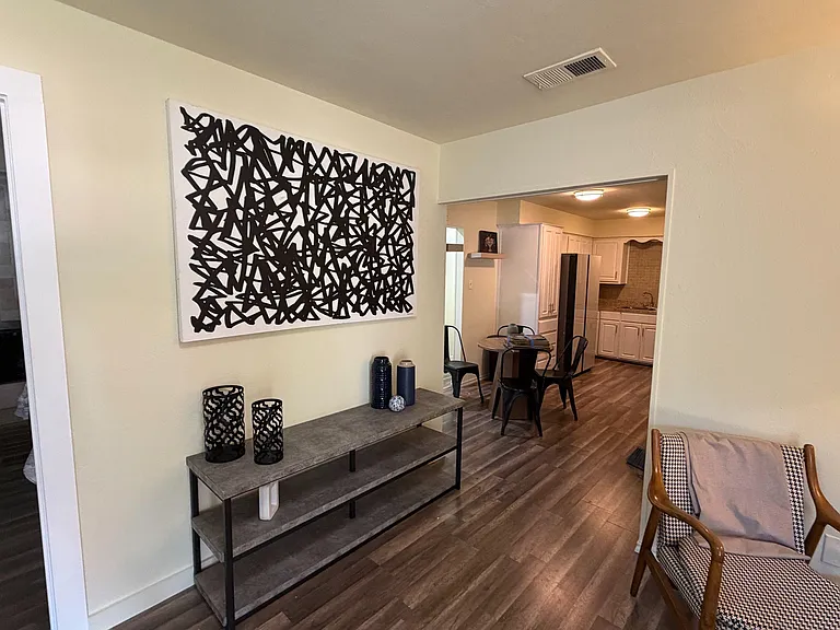 Open-concept dining nook flows into the kitchen with ample cabinets, full-size fridge, and easy-care flooring.