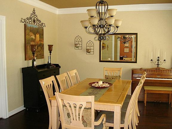 Large formal dining room. The picture window has full shutters.