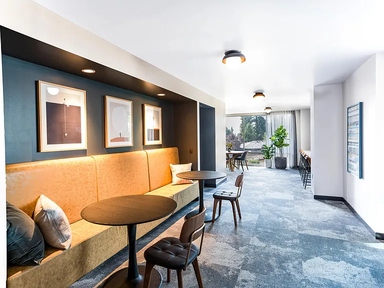 Thoughtfully designed gathering spaces at Modera Shoreline offer inviting corners to work, connect, or unwind surrounded by natural light and comfort.