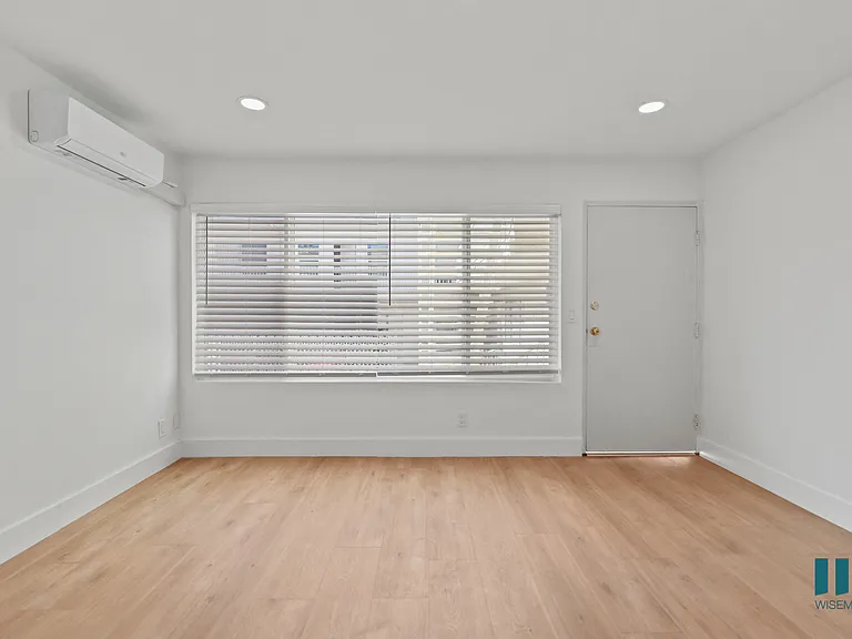 Front Entrance in Living Room with Vinyl Flooring and Large-Size Windows