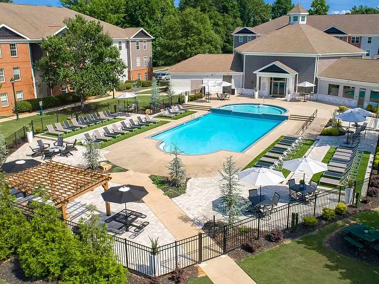 Relax at our fenced pool area featuring ample lounge seating for residents, professionally operated by Highlands Vista Group.
