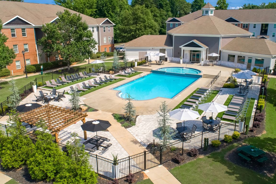 Relax at our fenced pool area featuring ample lounge seating for residents, professionally operated by Highlands Vista Group.