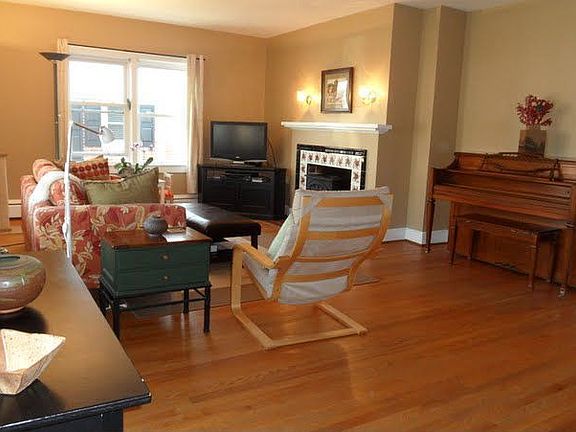 Enormous living room with fireplace and hardwood flooring!