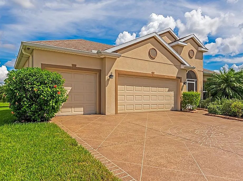 Three car garage with built-in storage cabinets, work space and wash sink