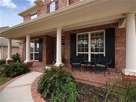 Southern charm abounds with a big front porch overlooking perennial flower beds and beautiful trees.