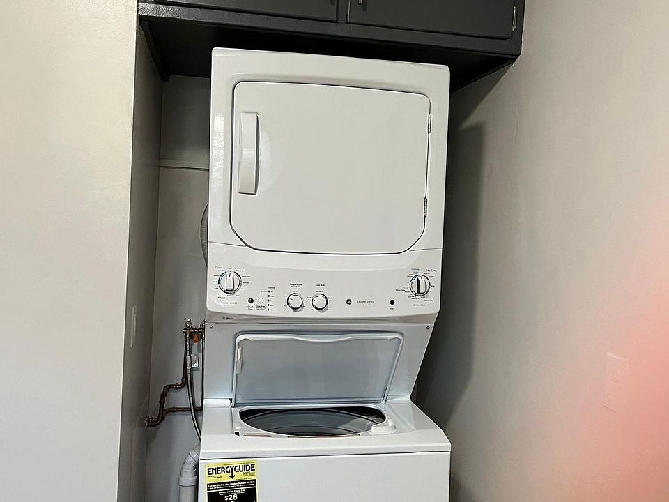 New stackable washer and dryer in unit.