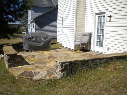 Stone patio with built-in BBQ grill. Stone seating will hold